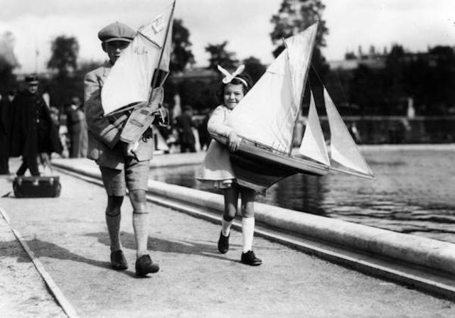 Children playing with toys around 100 years ago.