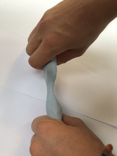 pulling blu-tack between two hands