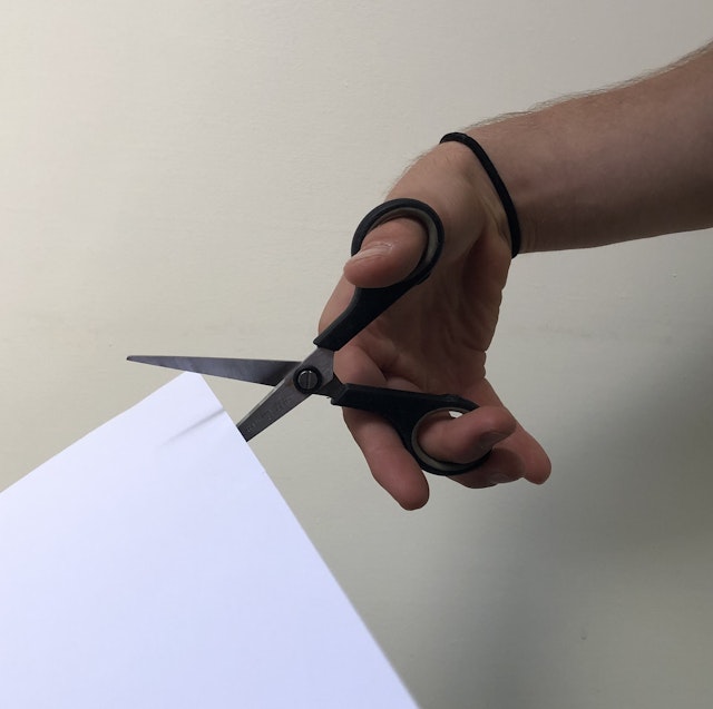 Which type of force do you use when you close scissors to cut paper?