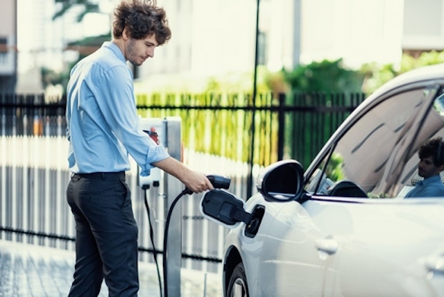 Someone charging an electric car 