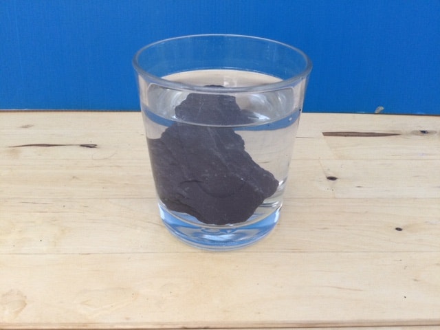 Look at this slate in a glass of water. It is a test for permeability. What does it show you about the permeability of slate?  